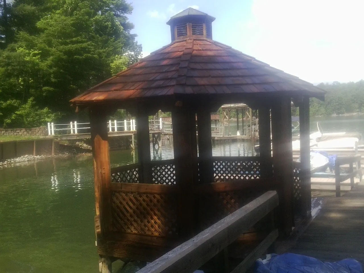 Cedar shake gazebo roof rebuilt on a lake dock in Lindsay